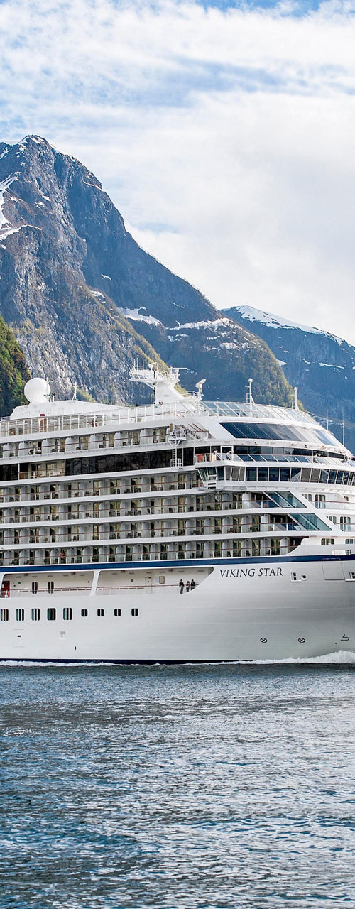 Luxury cruise ship in scenic fjord