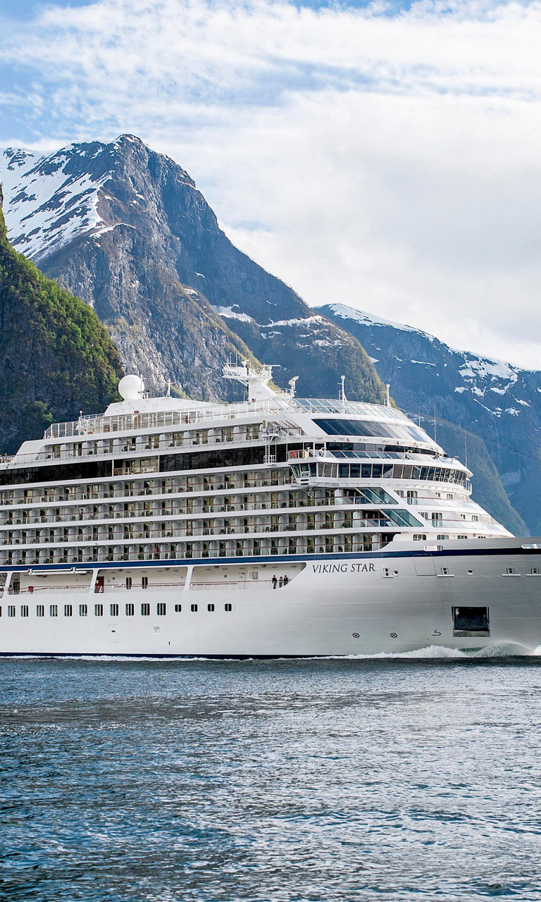 Luxury cruise ship in scenic fjord