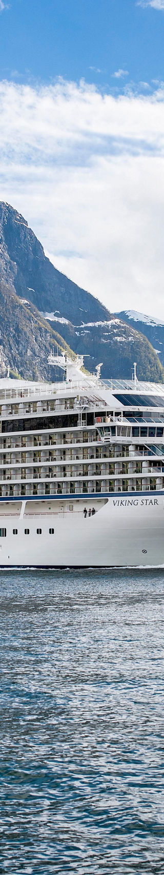 Luxury cruise ship in scenic fjord