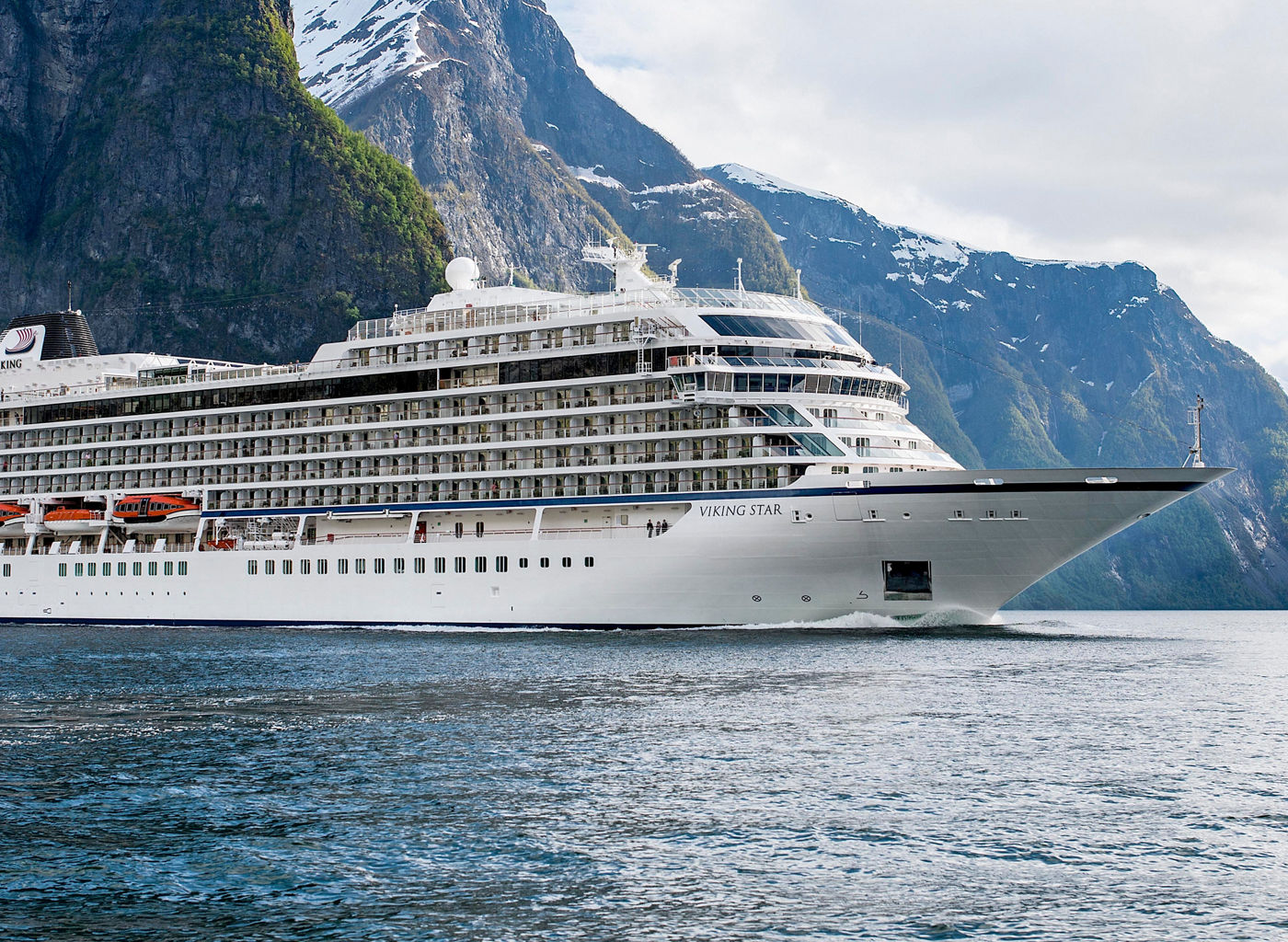 Luxury cruise ship in scenic fjord
