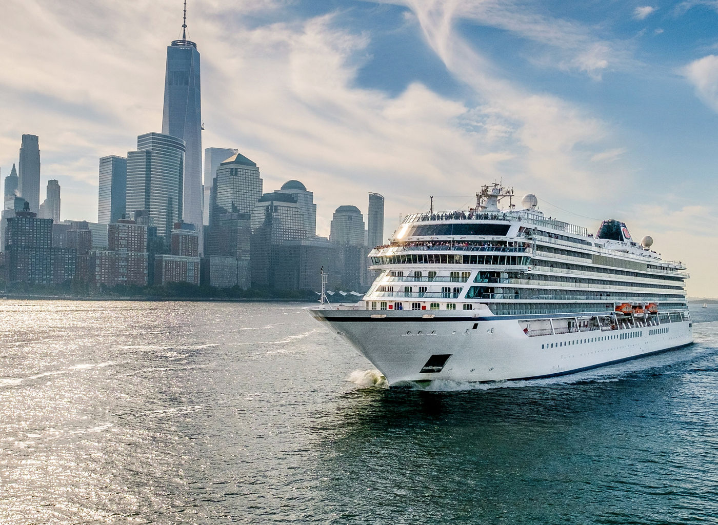 Luxury cruise ship sailing near city skyline