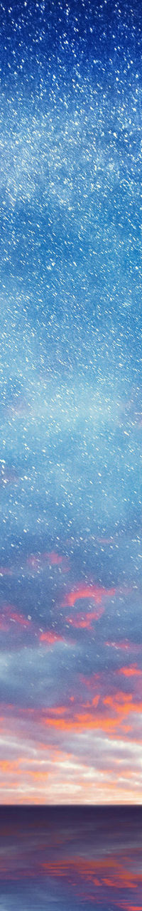 Starry night sky over calm ocean