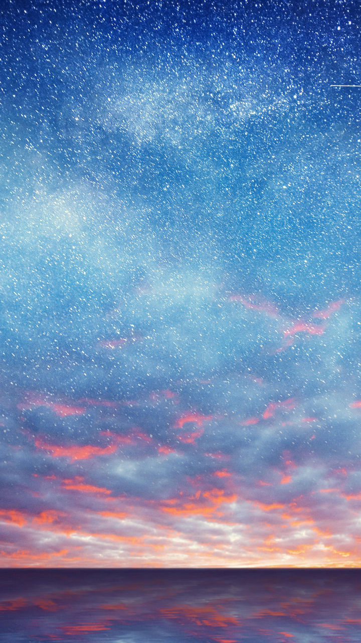 Starry night sky over calm ocean