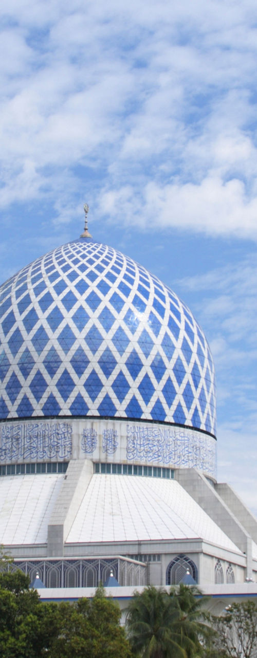 Blue mosque with tall minarets under sky