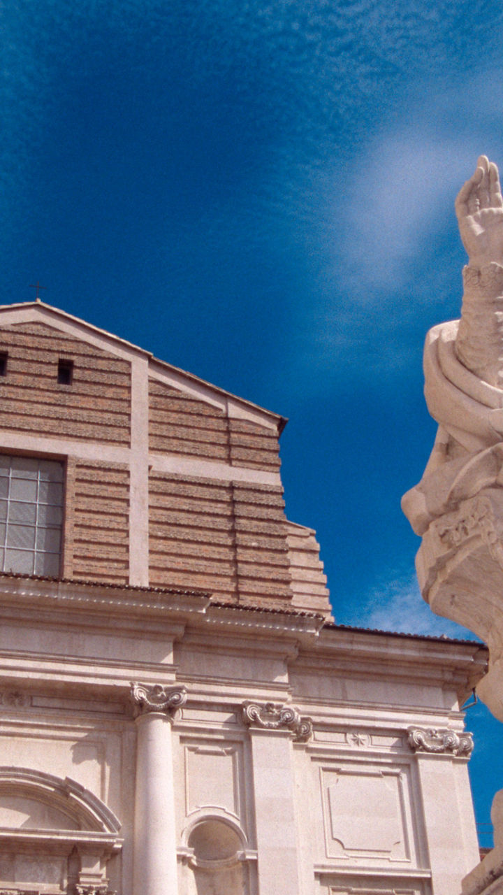 Historic church facade with marble statue