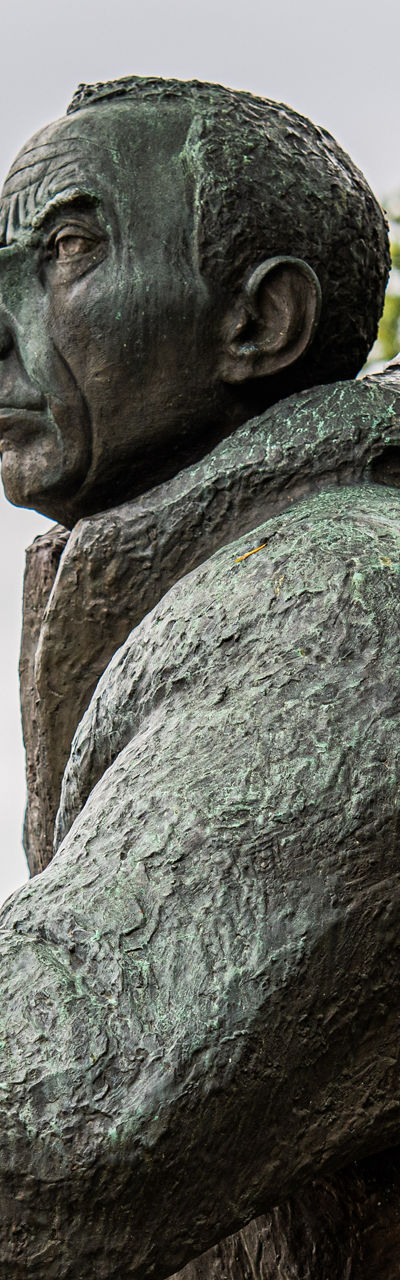 Bronze statue of a hiker near lake
