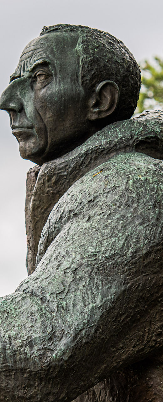 Bronze statue of a hiker near lake