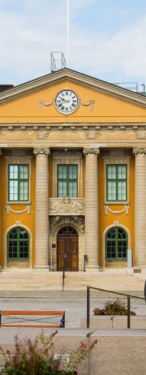 Historic yellow town hall with statue