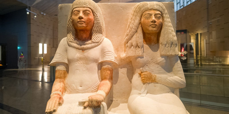 Ancient Egyptian statues in museum exhibit