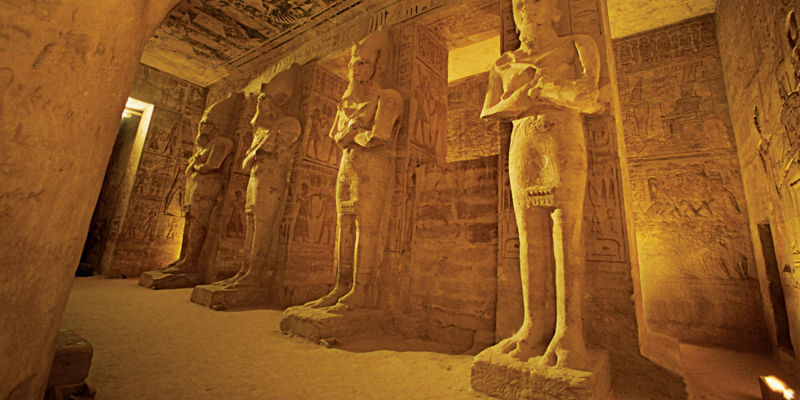 Ancient Egyptian statues in temple interior