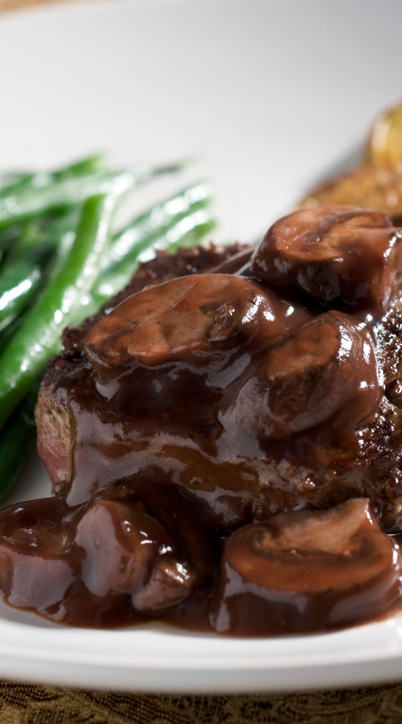 Steak with mushroom sauce and vegetables