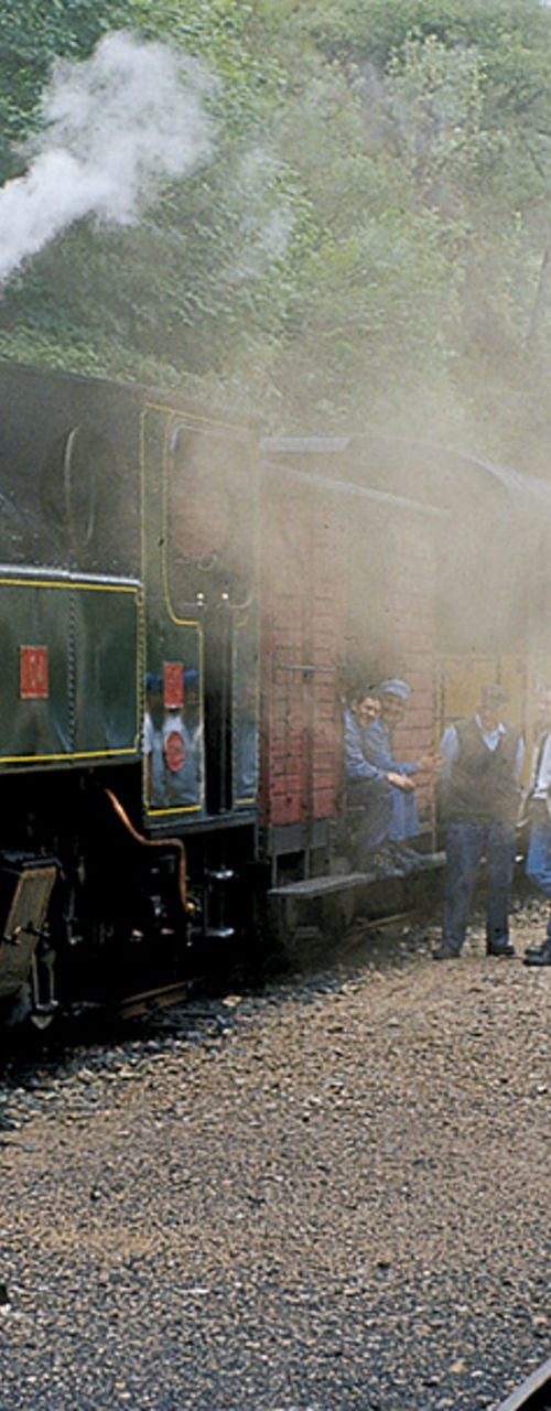 Vintage steam train at rural station