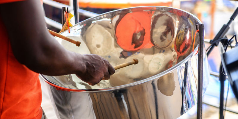 Musician Playing Shiny Steel Pan Drum
