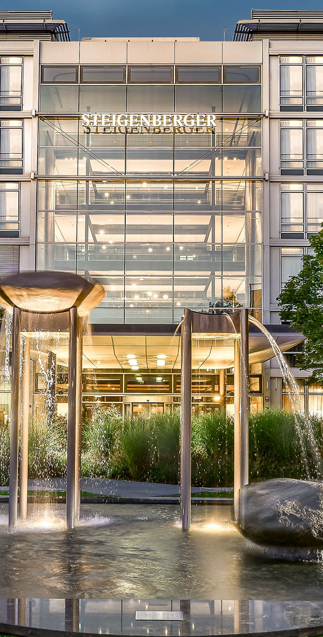Modern hotel exterior with fountain view