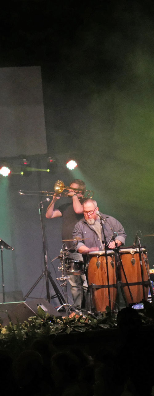 Live band performing on stage with visuals