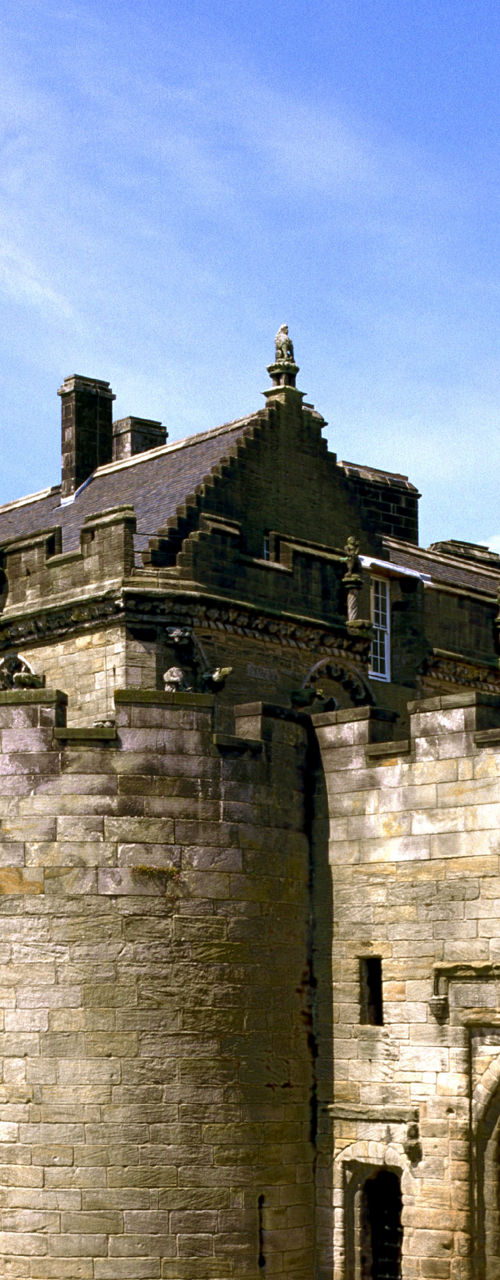 Historic stone castle with British flag