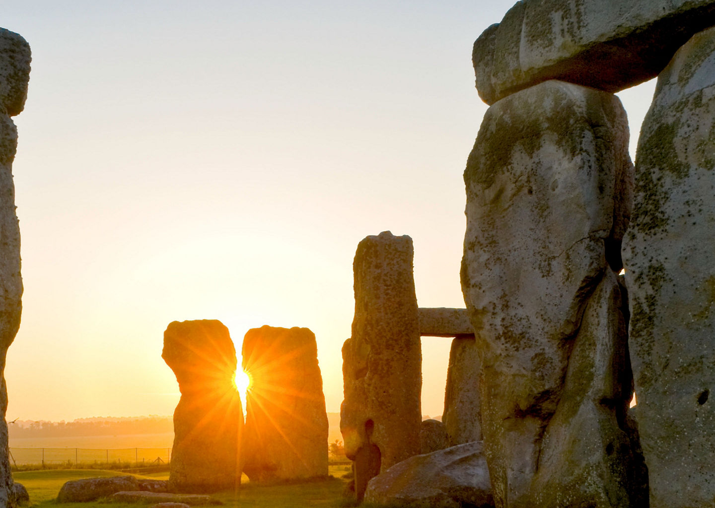 Stonehenge at sunrise with glowing sun
