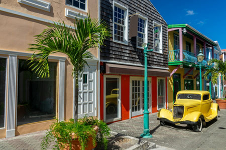 Vintage yellow car on colorful street