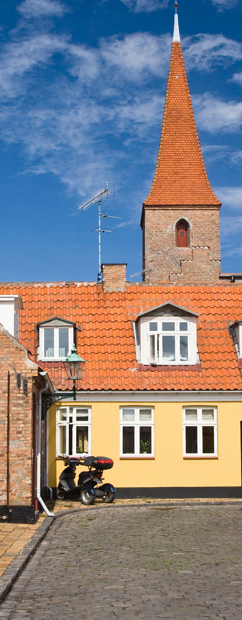 Colorful historic street with church spire