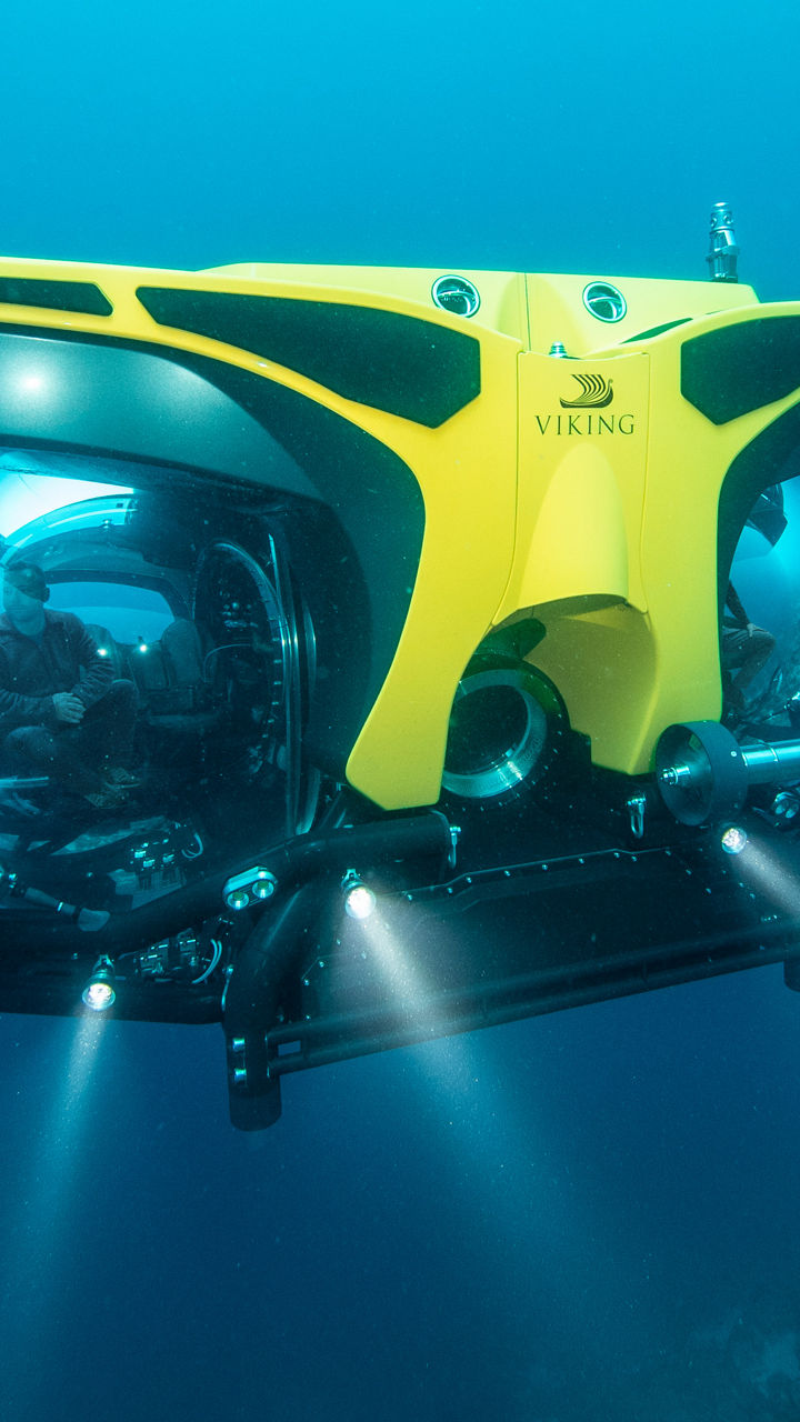 Yellow underwater drone exploring deep ocean