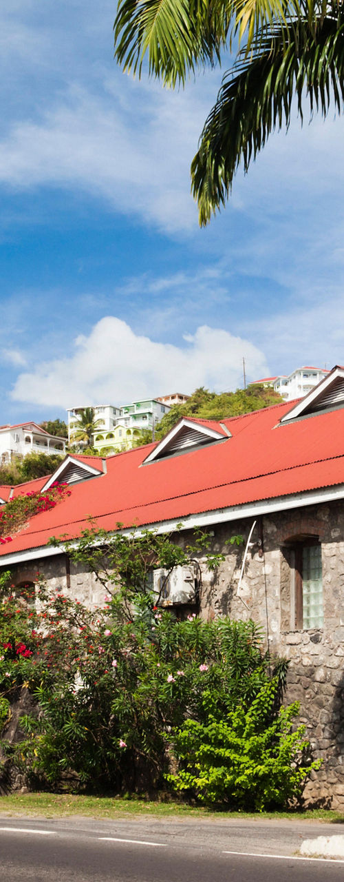 Historic stone building with red roof and chimney