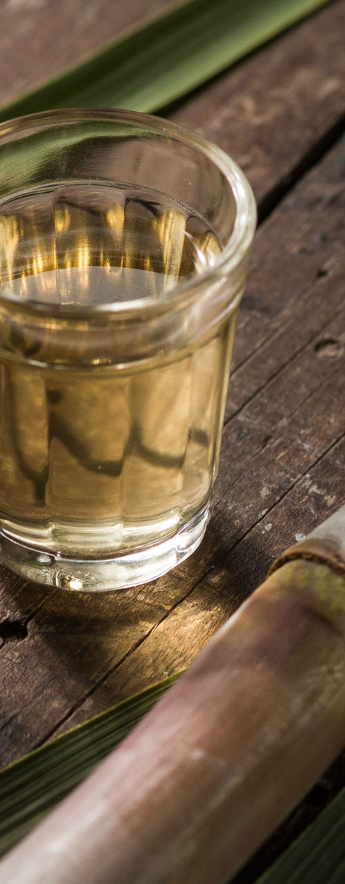 Sugarcane juice shots on rustic wooden table