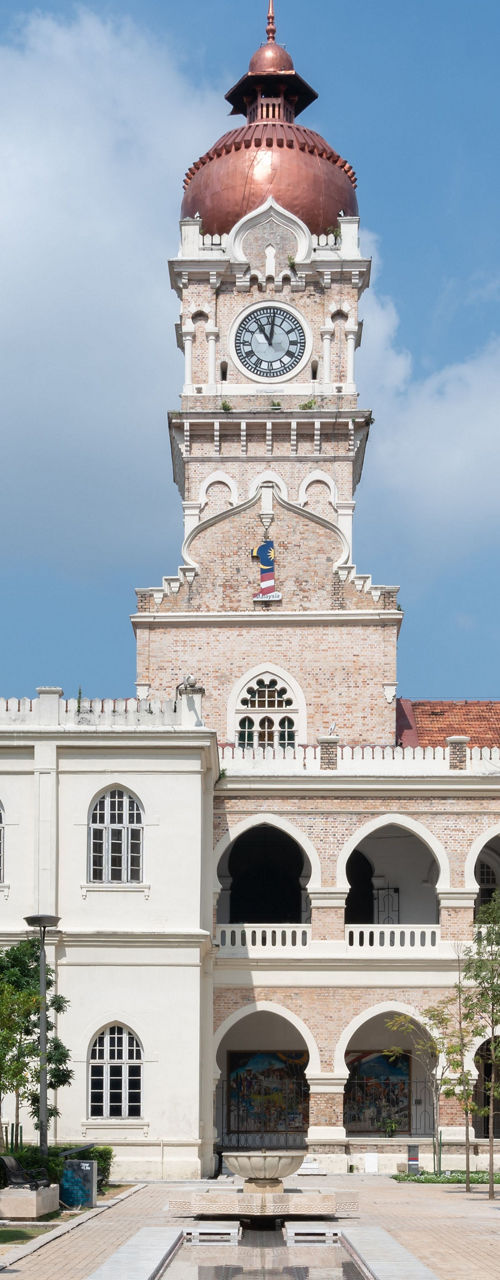 Historic clock tower courtyard on sunny day