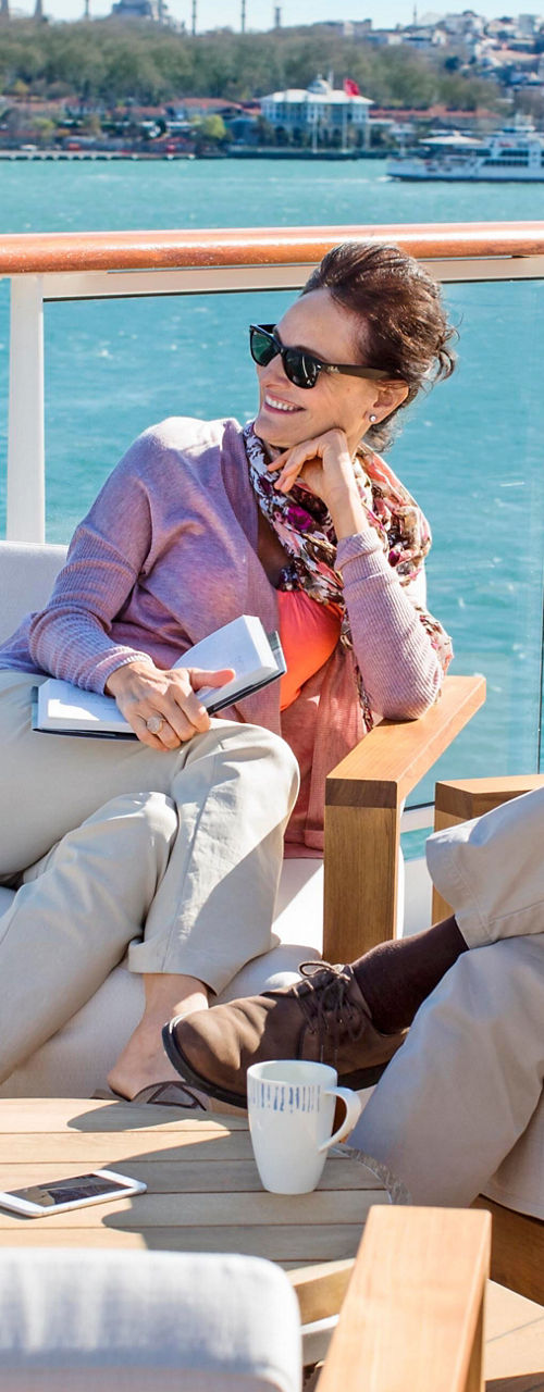 Couple relaxing on yacht deck with ocean view
