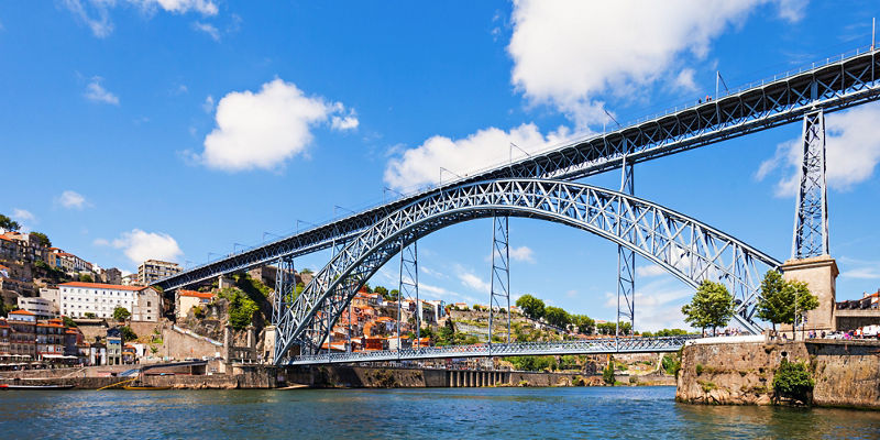 Steel arch bridge over river in city
