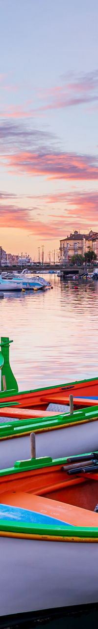 Colorful boats docked in scenic canal