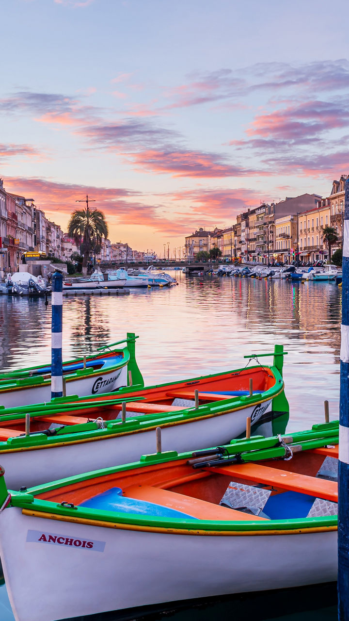 Colorful boats docked in scenic canal