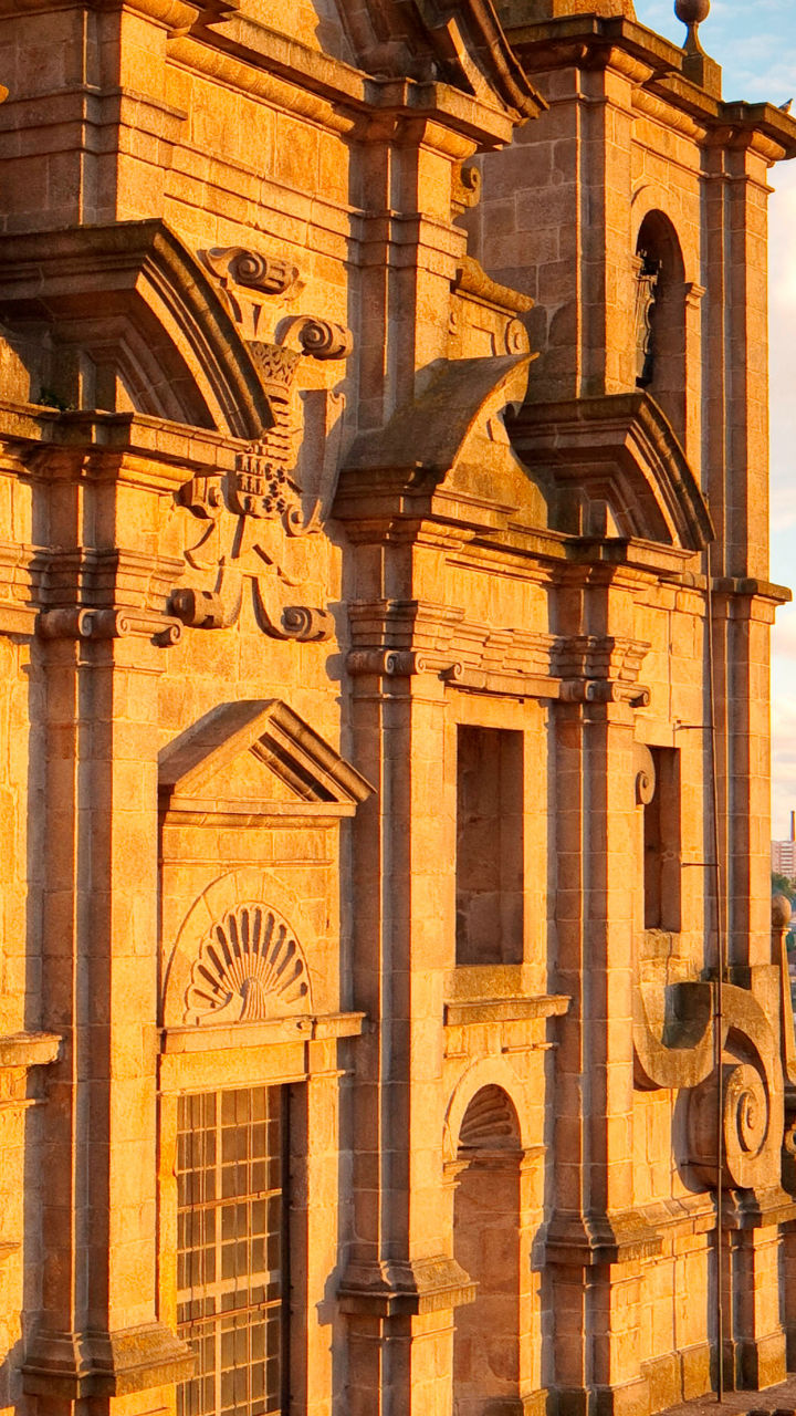 Historic church overlooking city at sunset