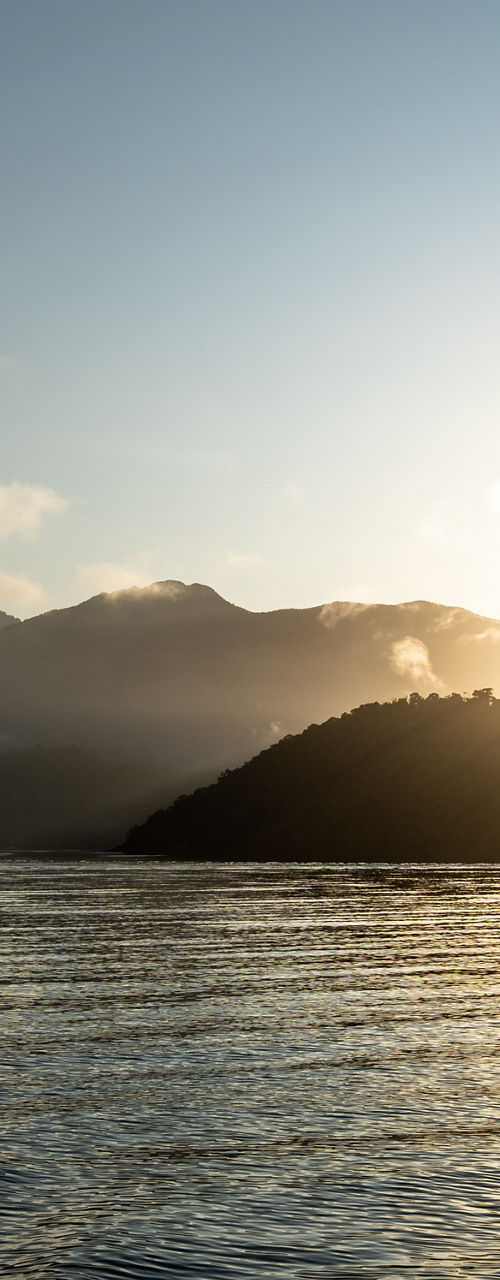Sunrise over serene mountain lake
