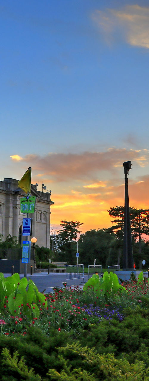 Historic building with American flag at sunset