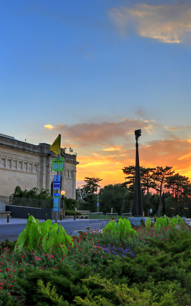 Historic building with American flag at sunset