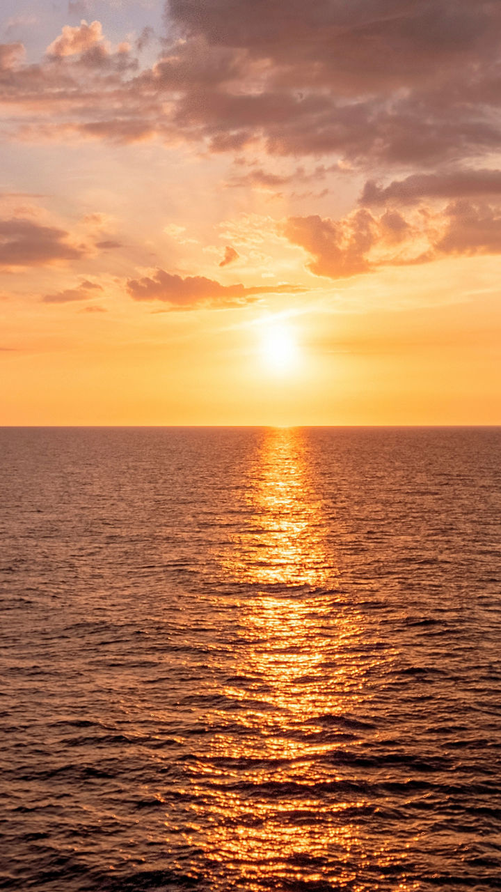 Serene ocean sunset with vibrant clouds