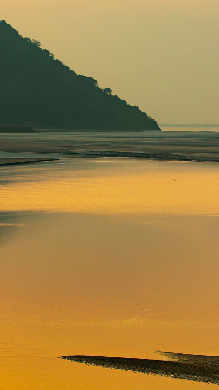 Serene river at sunset with lone boat