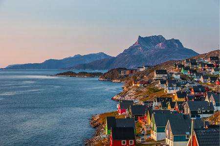 Colorful coastal town with mountain backdrop
