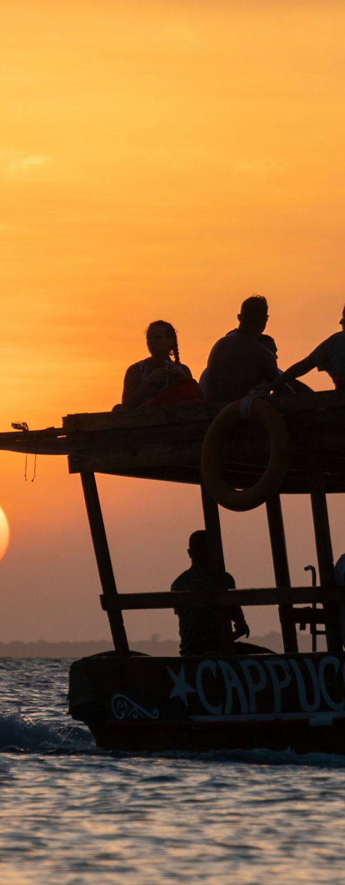 Sunset boat ride with silhouetted passengers