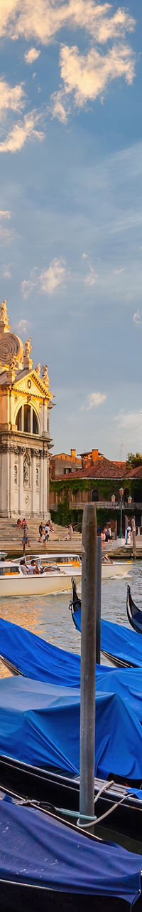 Gondolas at sunset near historic basilica