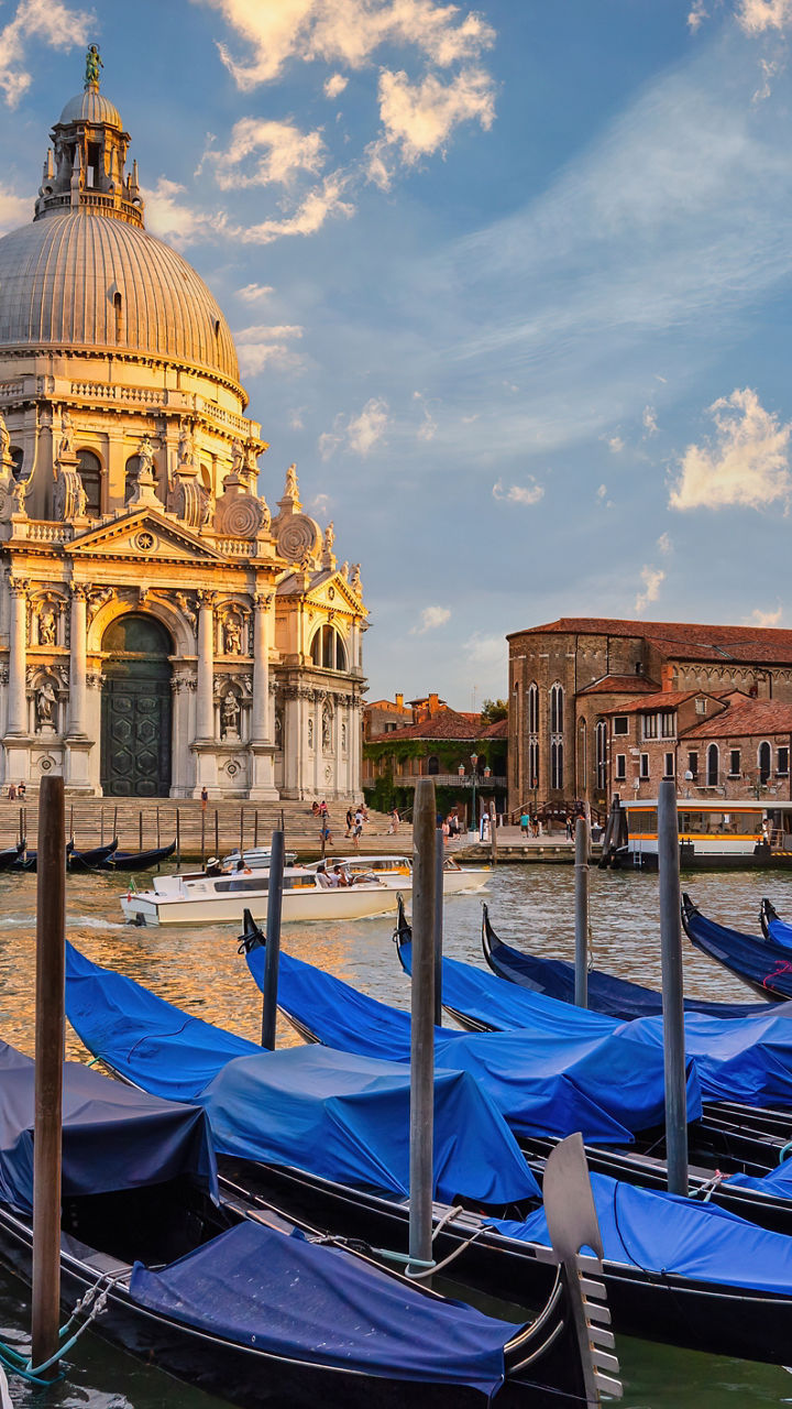 Gondolas at sunset near historic basilica