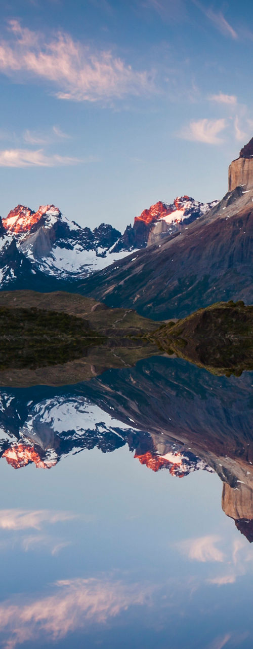 Majestic mountain range reflected in calm water