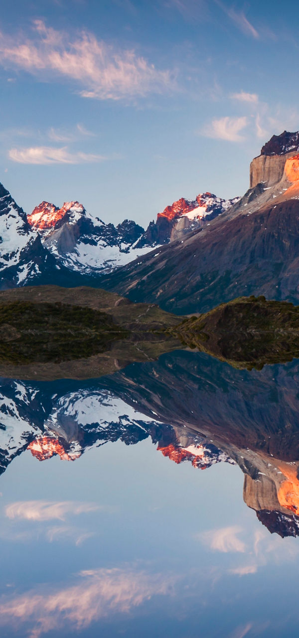 Majestic mountain range reflected in calm water