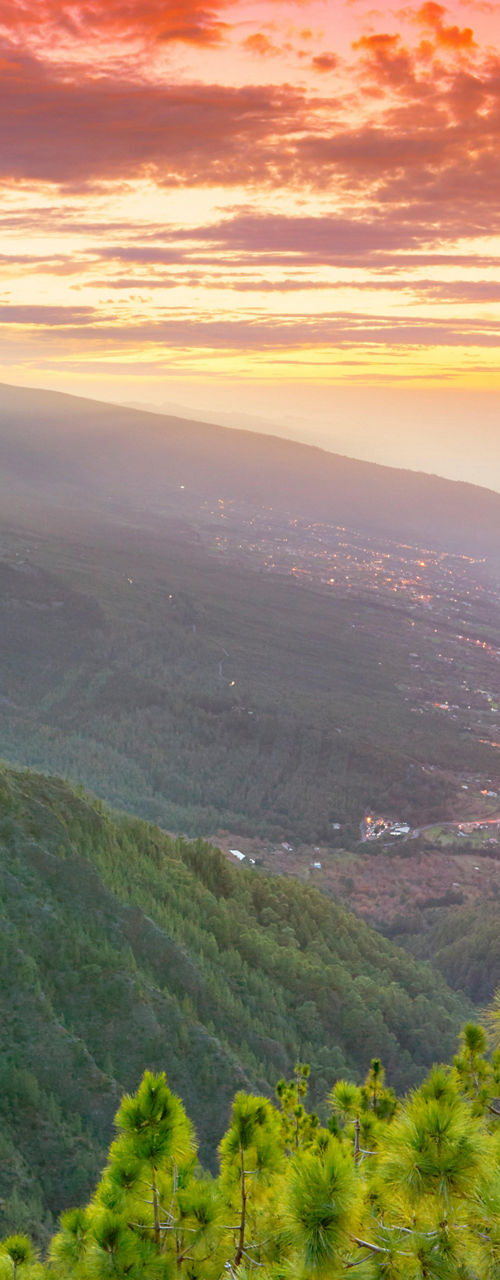 Vibrant sunset over lush mountain landscape