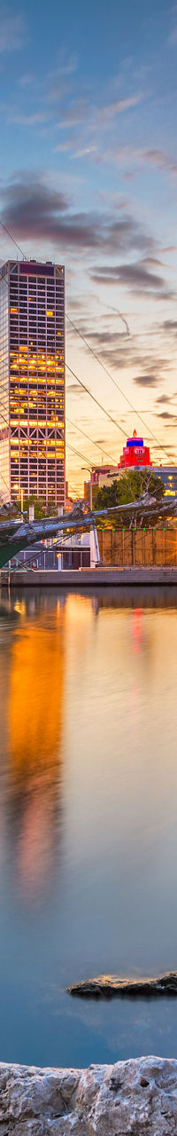 Milwaukee skyline with sailboat at sunset