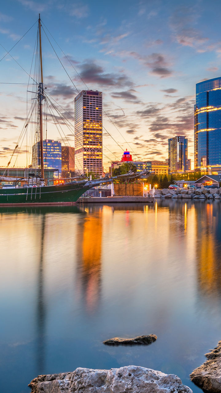 Milwaukee skyline with sailboat at sunset