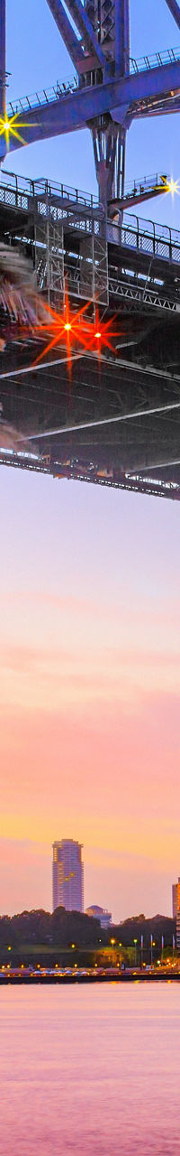 Sydney Harbour Bridge at sunset with skyline