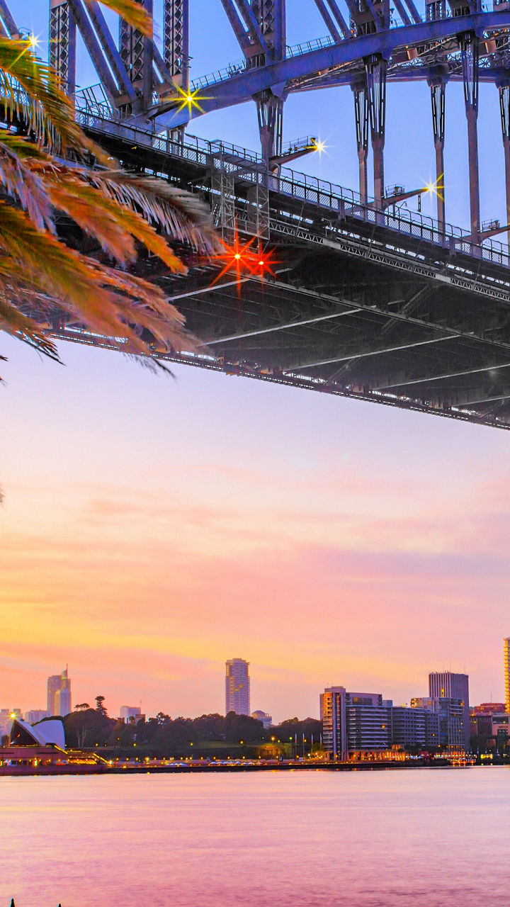 Sydney Harbour Bridge at sunset with skyline