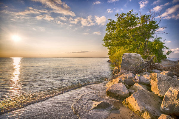 Serene Beach Sunset with Rocky Shoreline