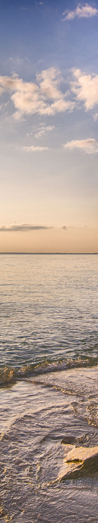 Serene Beach Sunset with Rocky Shoreline